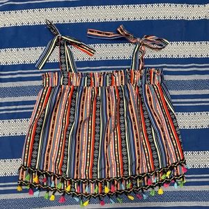 Striped and aztec sleeveless top with tie straps and tassels.
